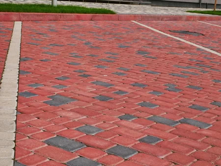 Technician sealing a brick paver patio in mechanicsville va after professional cleaning